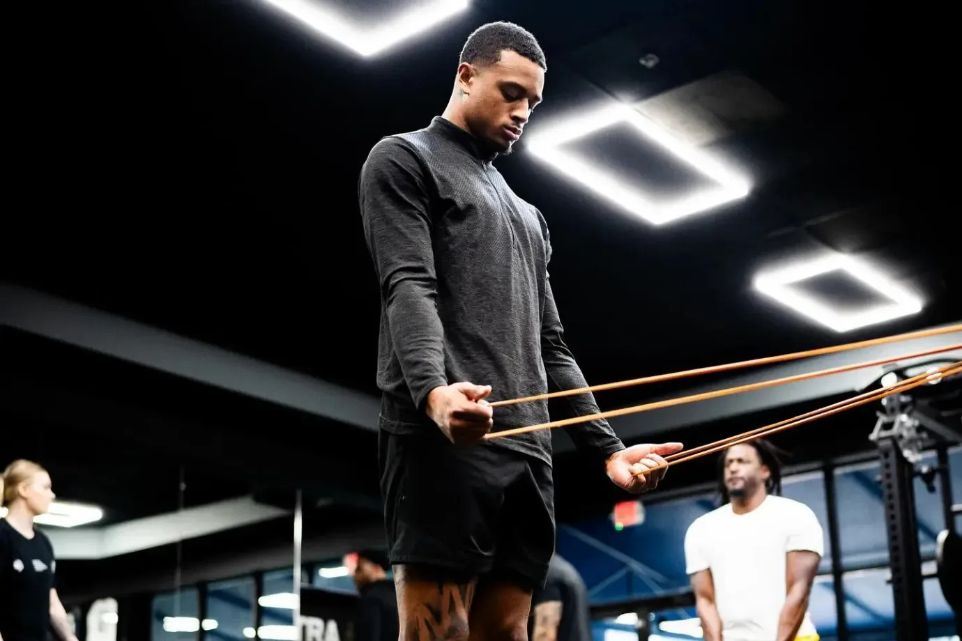 A basketball player working through a resistance-band rehab exercise